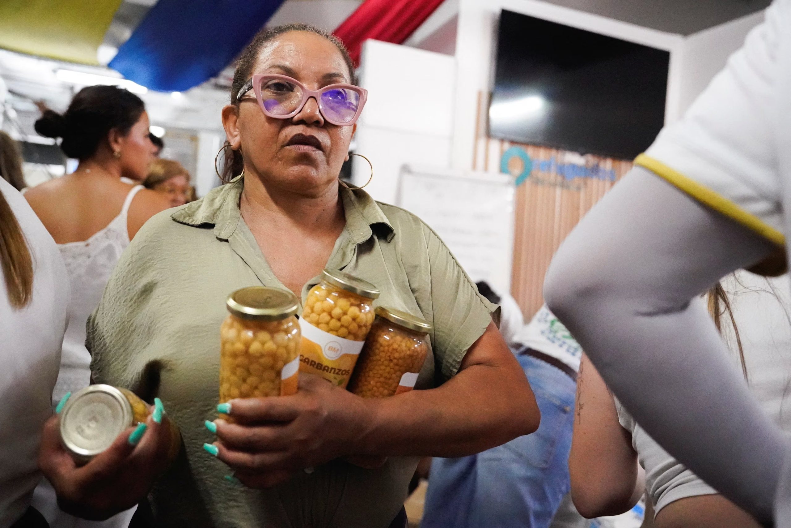A woman carries food supplies as Venezuelans living in Spain collect medicines and food after deadly earthquakes hit Venezuela, in Madrid, Spain, June 27, 2026. REUTERS/Ana Beltran
