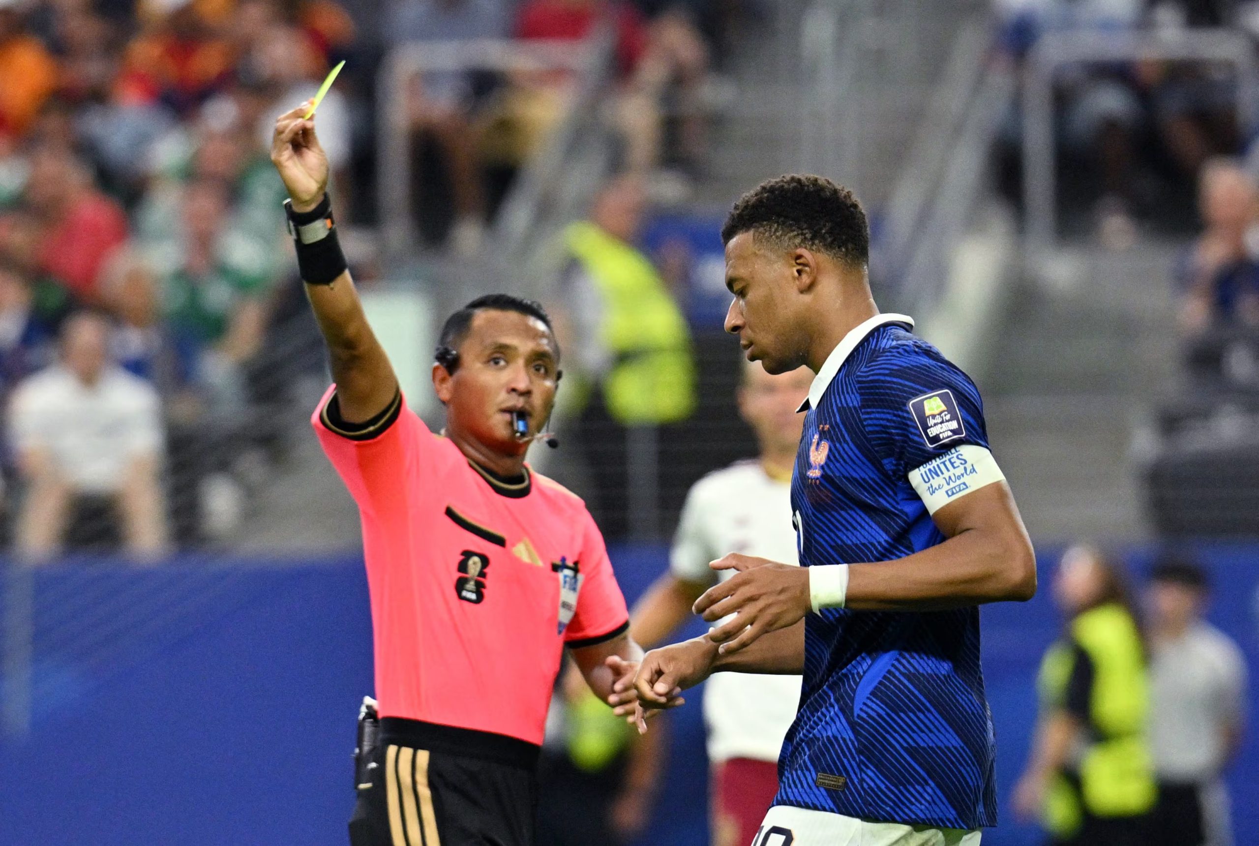 Soccer Football - FIFA World Cup 2026 - Semi Final - France v Spain - Dallas Stadium, Arlington, Texas, U.S. - July 14, 2026 France's Kylian Mbappe is shown a yellow card by referee Ivan Barton IMAGN IMAGES via Reuters/Jerome Miron