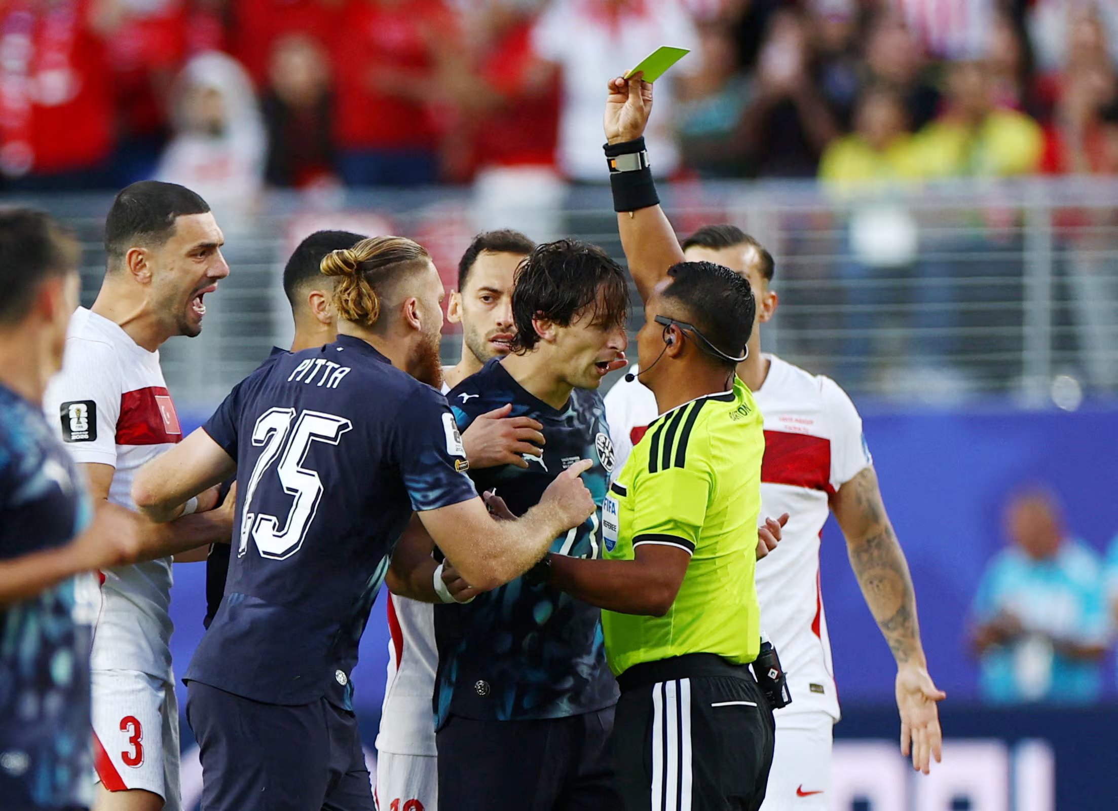 Soccer Football - FIFA World Cup 2026 - Group D - Turkey v Paraguay - San Francisco Bay Area Stadium, Santa Clara, California, U.S. - June 19, 2026 Paraguay's Matias Galarza is shown a yellow card by referee Ivan Barton REUTERS/Carlos Barria TPX IMAGES OF THE DAY