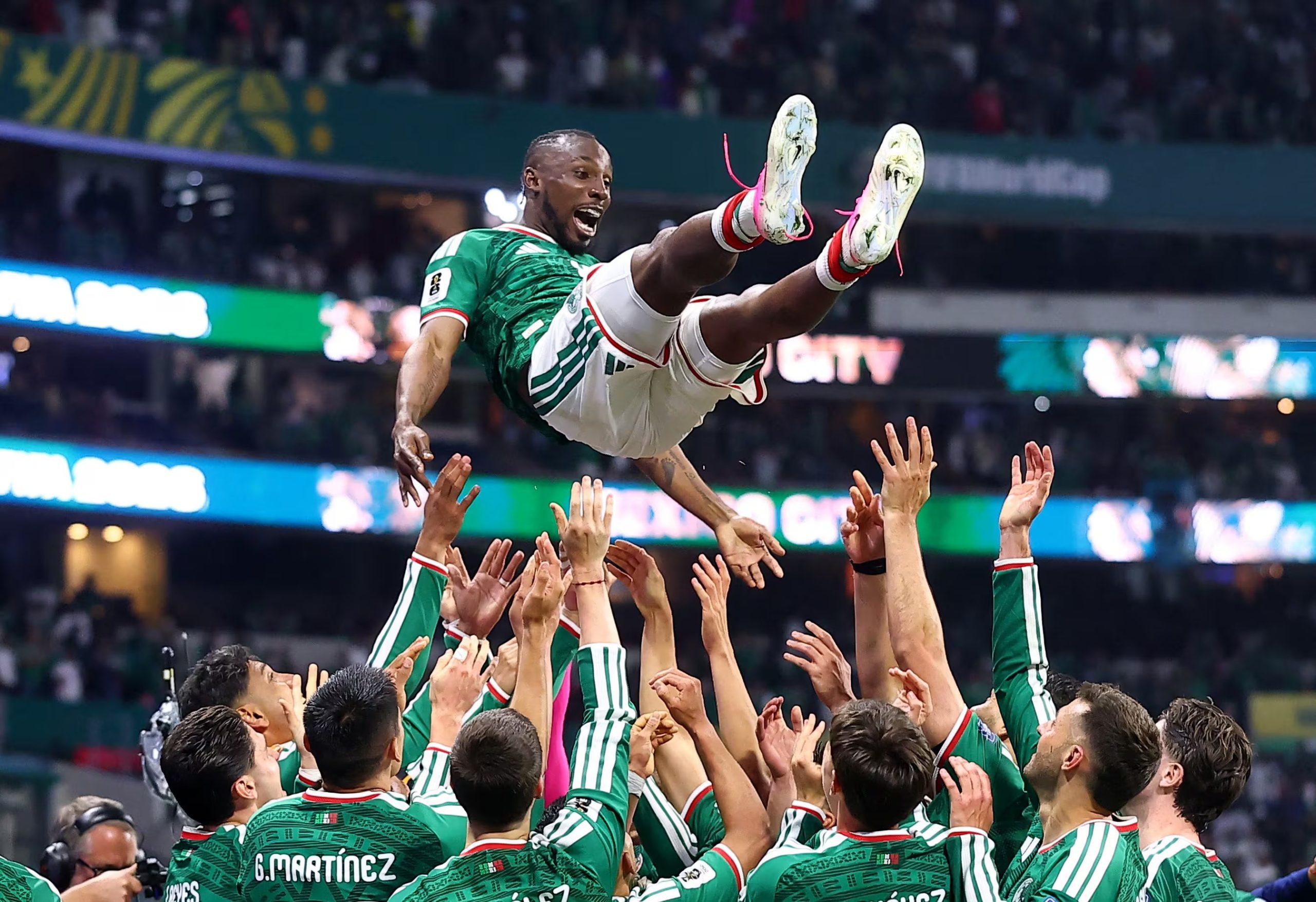 Soccer Football - FIFA World Cup 2026 - Round of 32 - Mexico v Ecuador - Estadio Azteca, Mexico City, Mexico - June 30, 2026 Mexico's Julian Quinones is thrown in the air in celebration by teammates after the match as Mexico qualify for the round of 16 stage of the World Cup REUTERS/Eloisa Sanchez
